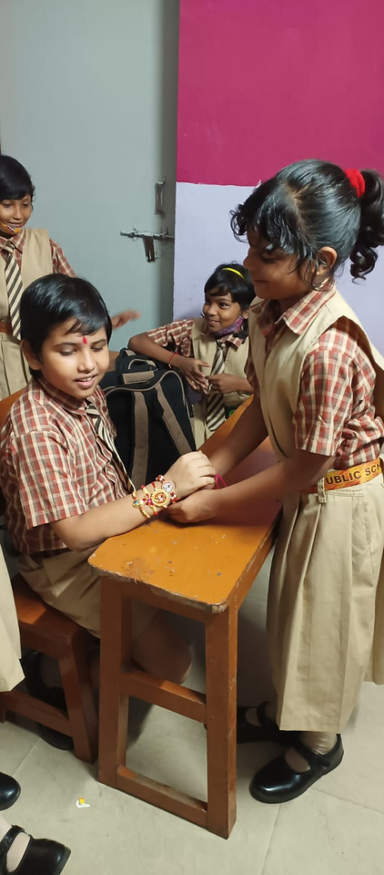 Students of N K Public School celebrating Raksha Bandhan, exchanging Rakhi and engaging in traditional festivities. The image captures the cultural celebration and the school’s commitment to fostering cultural and festive traditions